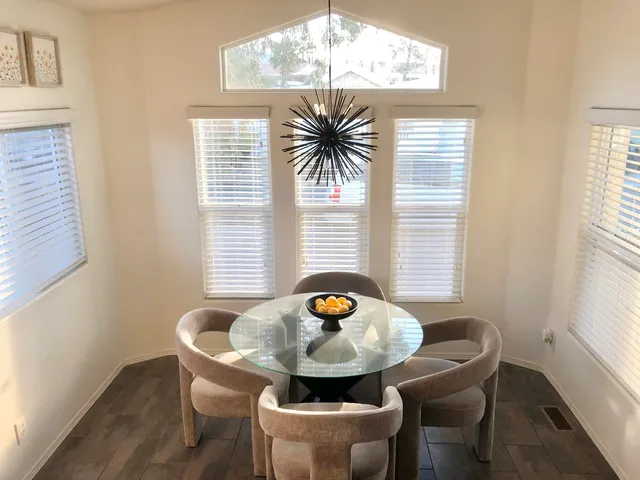 a dining room with furniture and window