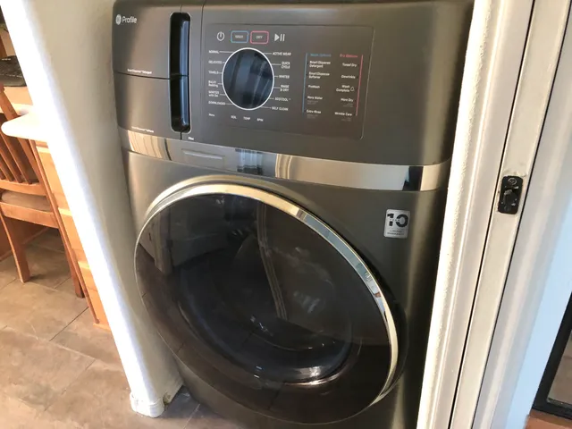 a view of a tennis ground and a cars park side of the road