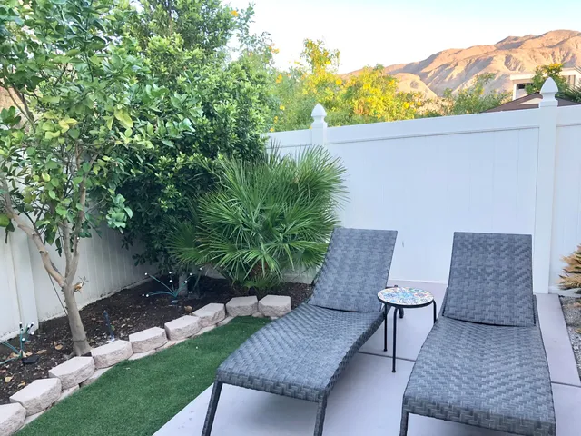 a view of a swimming pool with a table and chairs
