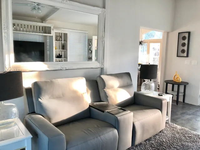 a kitchen with stainless steel appliances white cabinets and a fireplace