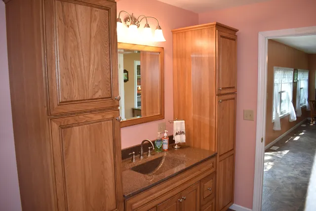 a bathroom with a sink a mirror and shower
