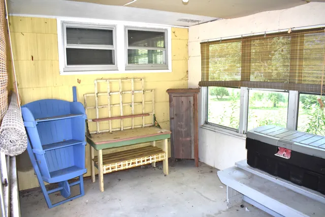 a bedroom with furniture and a window