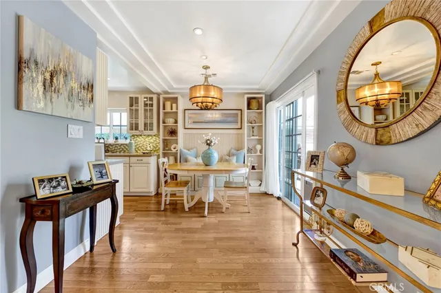 a view of a kitchen area with furniture and wooden floor