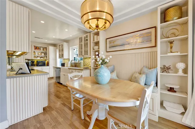 a view of a dining room with furniture and a chandelier