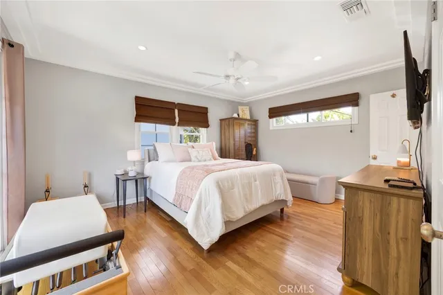 a bedroom with a bed window and a flat screen tv