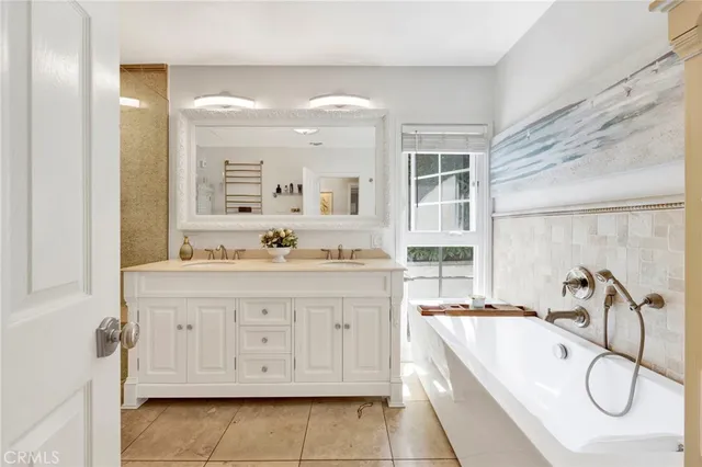 a spacious bathroom with a granite countertop sink and a mirror