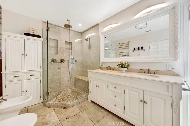 a spacious bathroom with a granite countertop sink mirror and shower