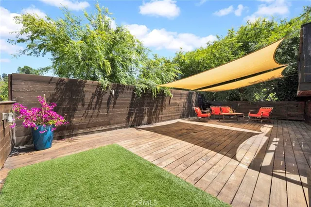 a view of a backyard with a garden and potted plants