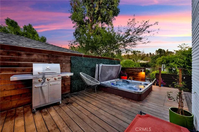 a wooden deck with patio and yard