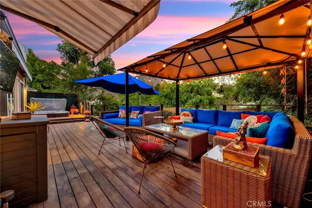 a view of outdoor sitting area with furniture and umbrella
