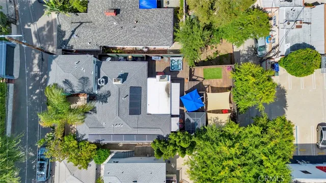 an aerial view of a house with yard and seating space