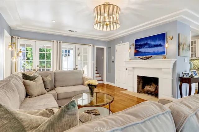 a living room with furniture a fireplace and a large window