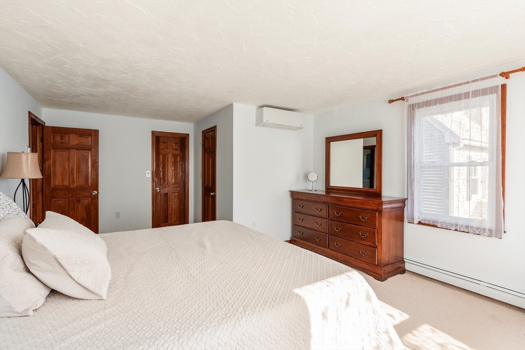 12 Loyola Circle Boston, MA 02132 - Photo 11 of 29 a bedroom with a bed and wooden floor