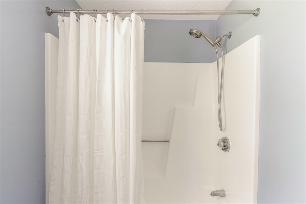 12 Loyola Circle Boston, MA 02132 - Photo 14 of 29 a bathroom with a shower and a curtain