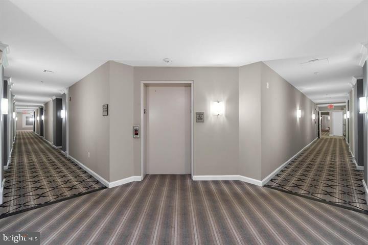 12000 Market Street, Unit 173 Reston, VA 20190 - Photo 15 of 47 Modern corridor with stylish lighting.