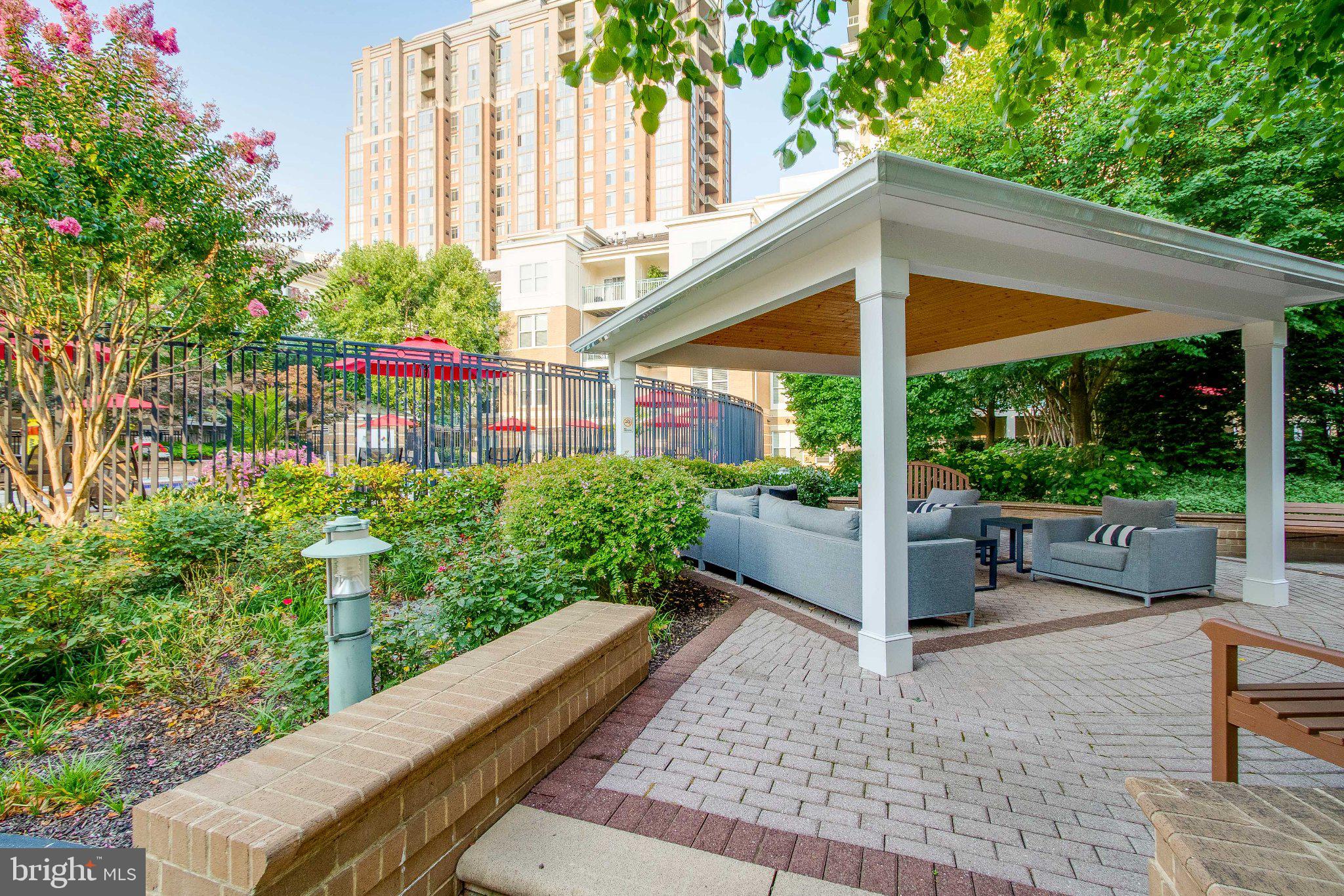 12000 Market Street, Unit 173 Reston, VA 20190 - Photo 46 of 47 Serene outdoor retreat with lush greenery.