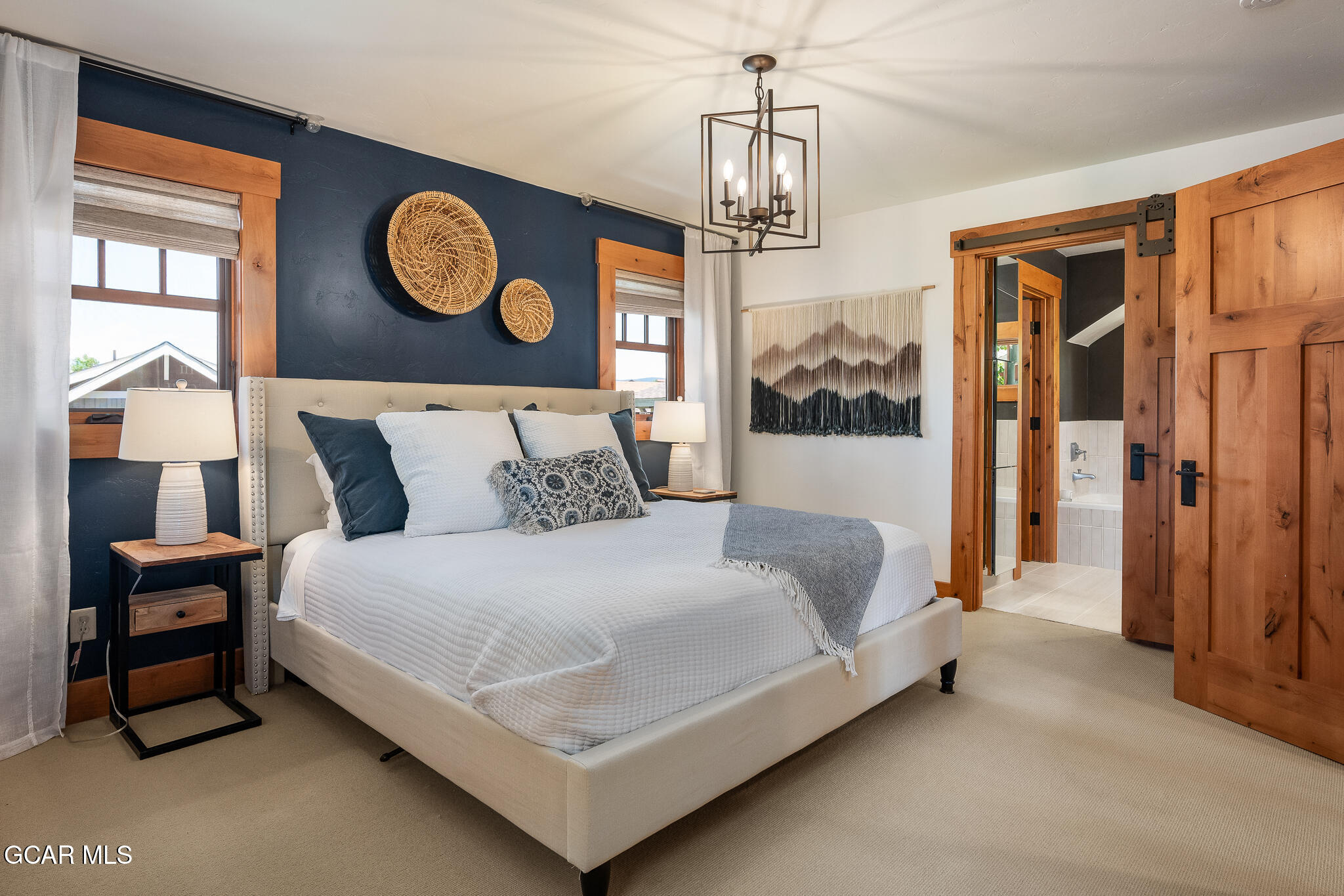 4 Rifle Shot Trail Fraser, CO 80442 - Photo 15 of 47 a bedroom with a bed and dresser with wooden floor