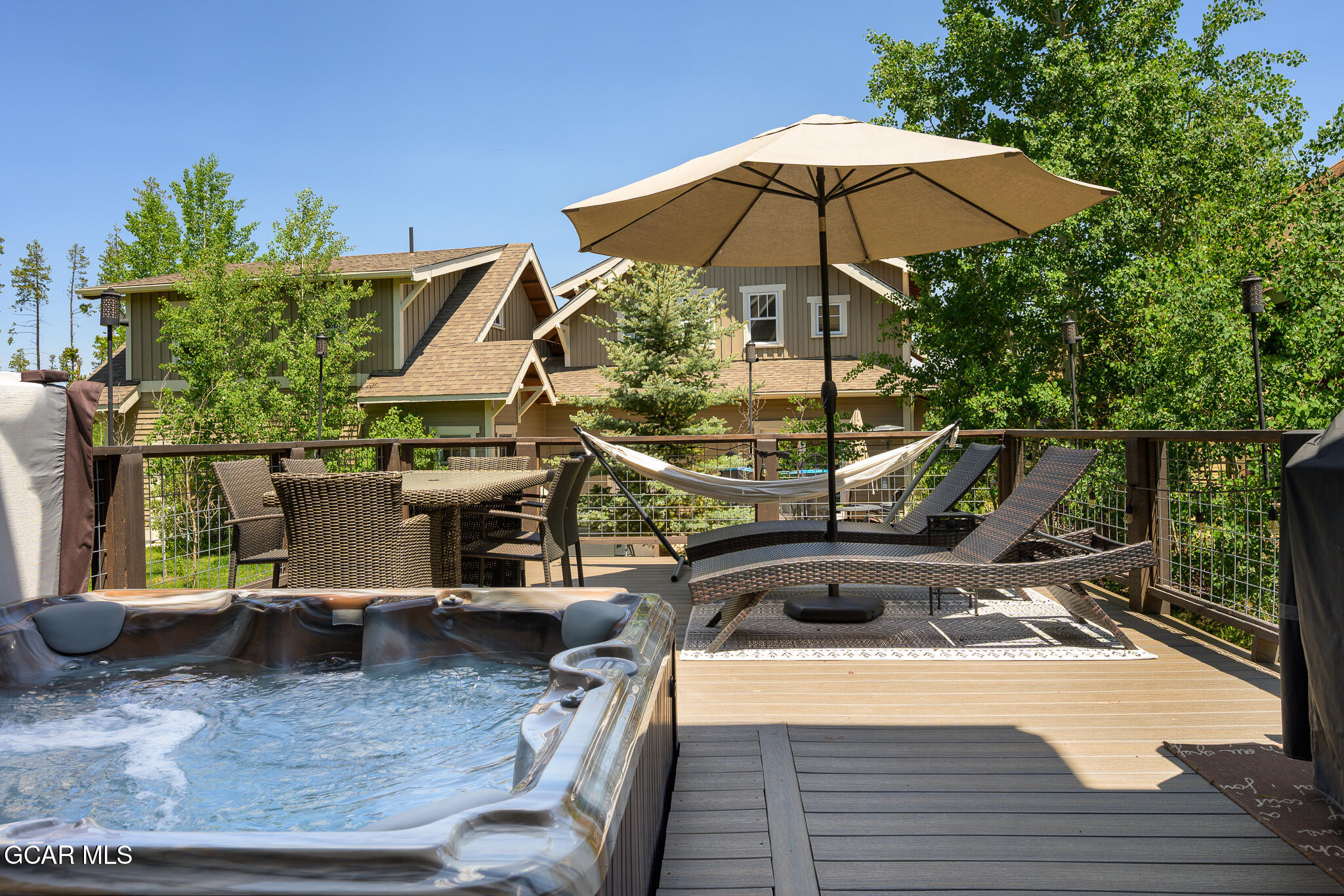4 Rifle Shot Trail Fraser, CO 80442 - Photo 36 of 47 a view of a patio with chairs and a table under an umbrella