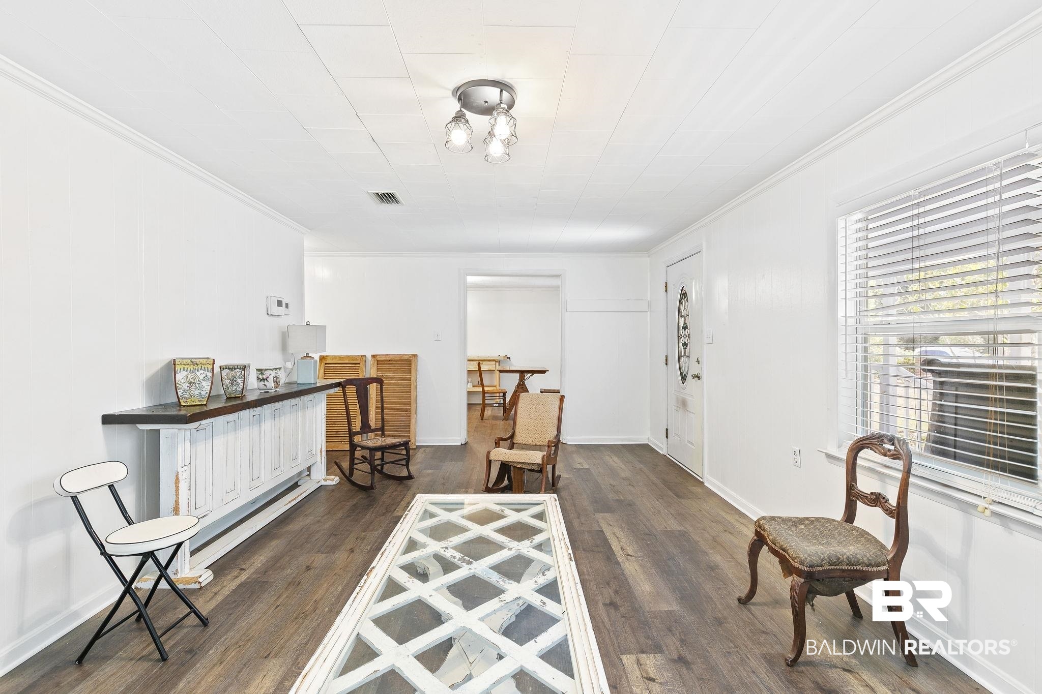 316 West Orchid Avenue Foley, AL 36535 - Photo 12 of 38 Living area with crown molding and dark wood-style flooring