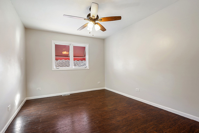 5338 State Road Burbank, IL 60459 - Photo 12 of 21 an empty room with wooden floor and windows