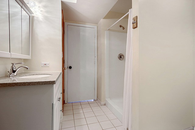 5338 State Road Burbank, IL 60459 - Photo 16 of 21 a bathroom with a sink and mirror