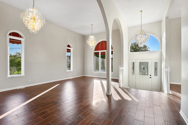 5338 State Road Burbank, IL 60459 - Photo 3 of 21 a view of a room with wooden floor chandeliers and kitchen view
