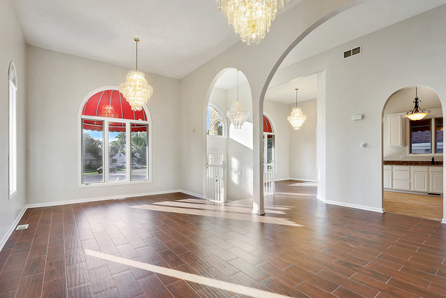 5338 State Road Burbank, IL 60459 - Photo 4 of 21 a view of a livingroom with wooden floor and a chandelier