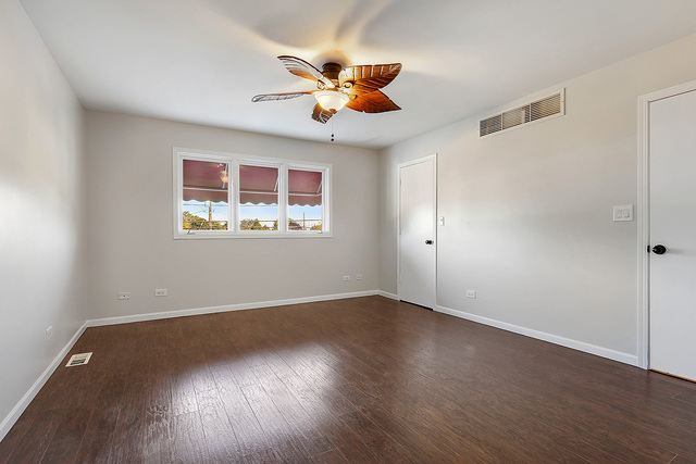 5338 State Road Burbank, IL 60459 - Photo 9 of 21 a view of an empty room with wooden floor and a window