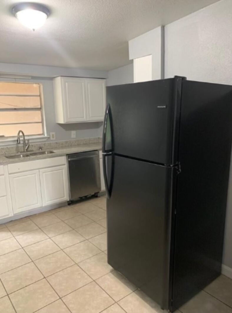 1013 Hackberry Street, Unit B San Marcos, TX 78666 - Photo 2 of 9 a kitchen with stainless steel appliances granite countertop a refrigerator and a sink