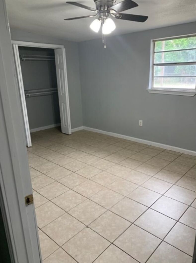 1013 Hackberry Street, Unit B San Marcos, TX 78666 - Photo 5 of 9 en empty room with window and stairs