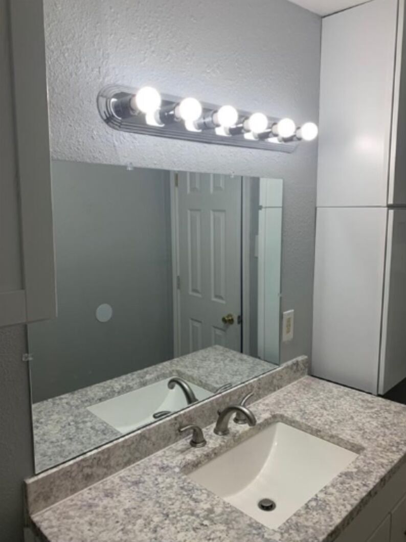 1013 Hackberry Street, Unit B San Marcos, TX 78666 - Photo 8 of 9 a bathroom with a granite countertop sink and a mirror