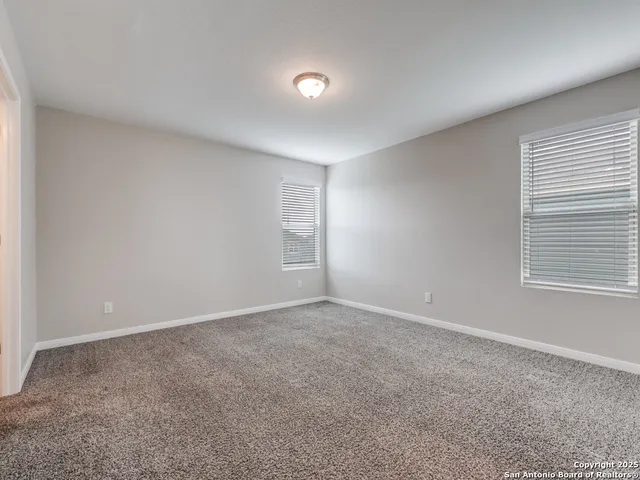 a view of an empty room and closet area