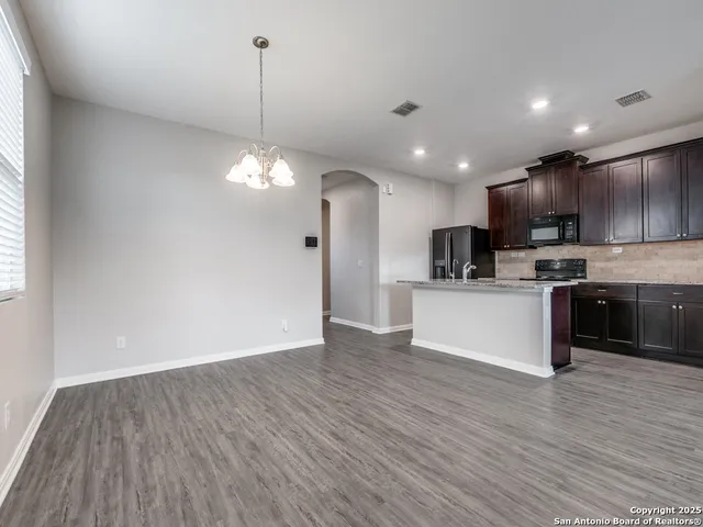 a view of kitchen with granite countertop cabinets and wooden floor