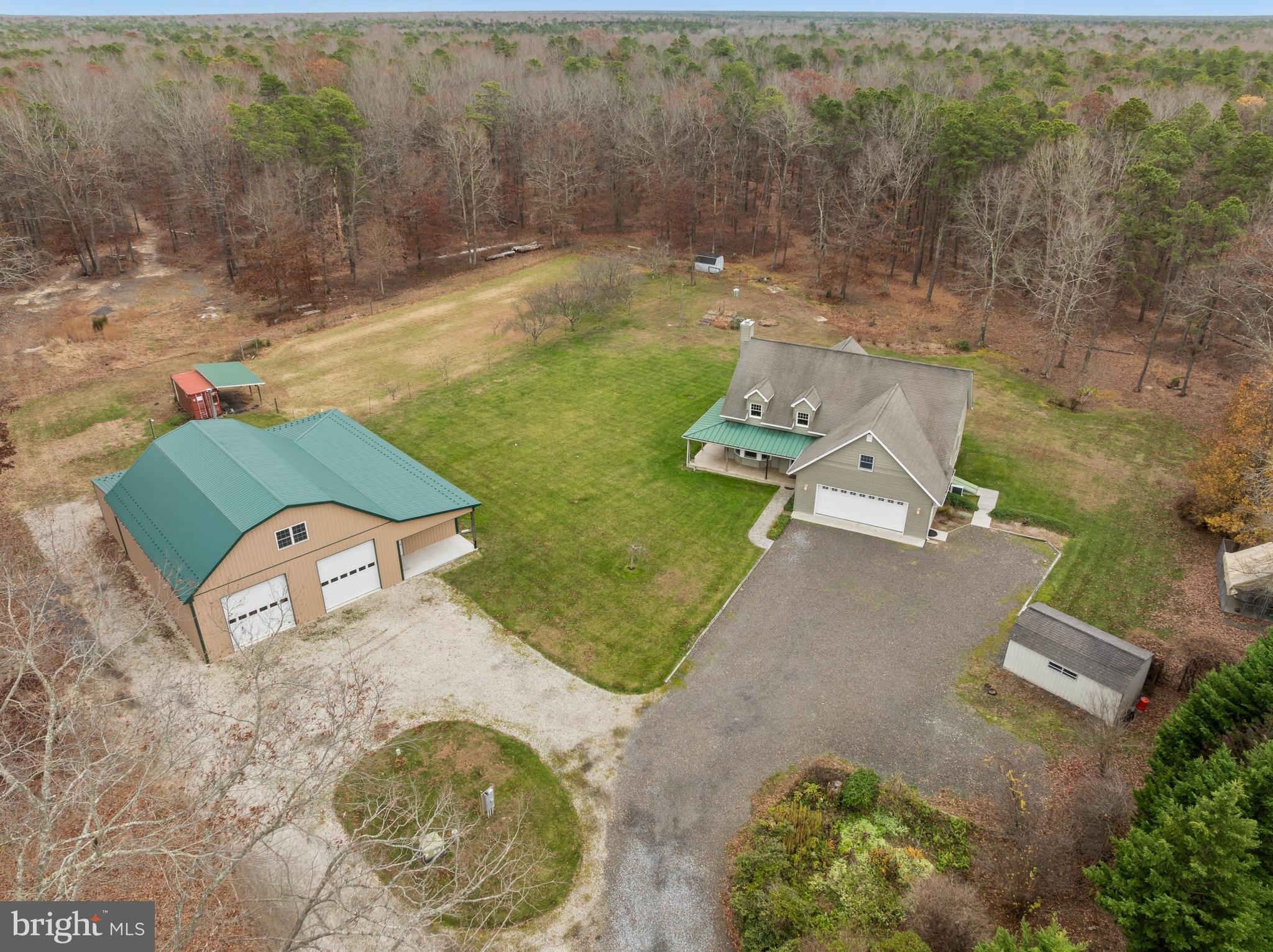 an aerial view of a house with a yard and lake view