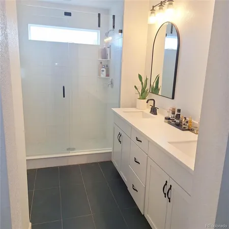 a bathroom with a toilet and a painting on the wall