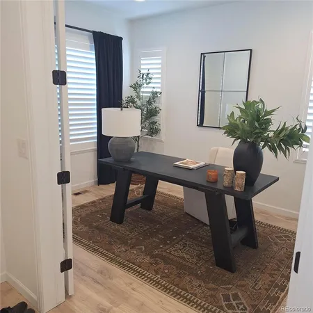a workspace with furniture and a potted plant