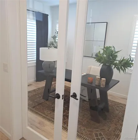 a view of a dining room with furniture and a potted plant