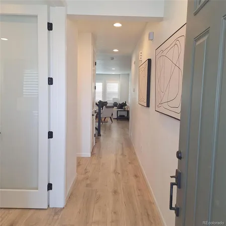 a living room with lots of furniture and chandelier
