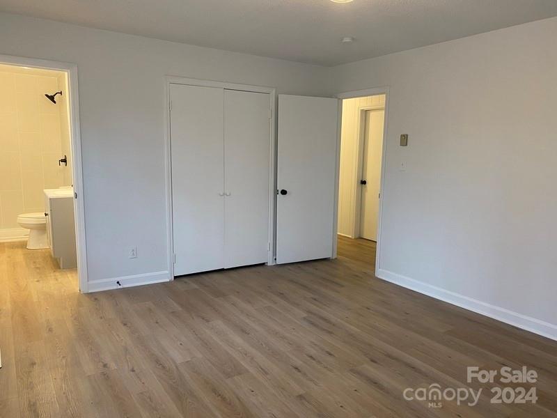 181 Spring Garden Avenue Kannapolis, NC 28081 - Photo 19 of 30 a view of an empty room with wooden floor
