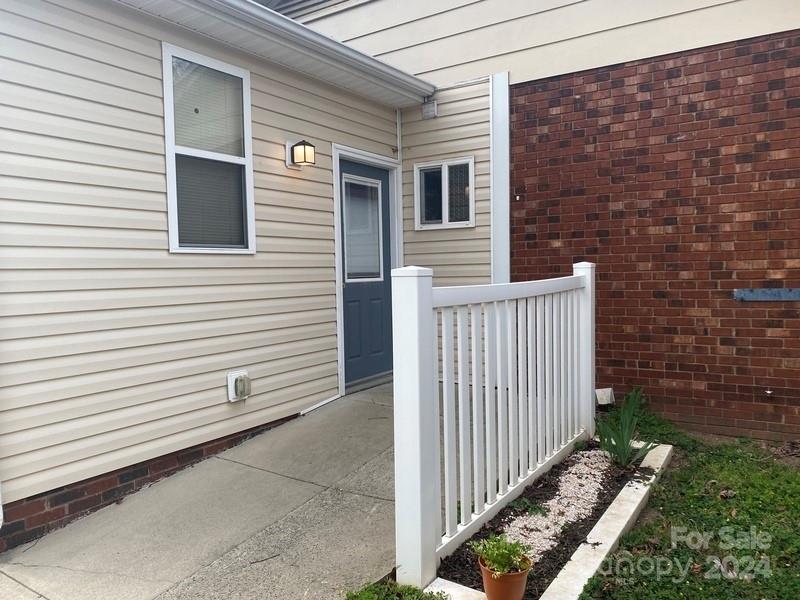 181 Spring Garden Avenue Kannapolis, NC 28081 - Photo 26 of 30 a view of a house with a small yard and wooden floor and fence
