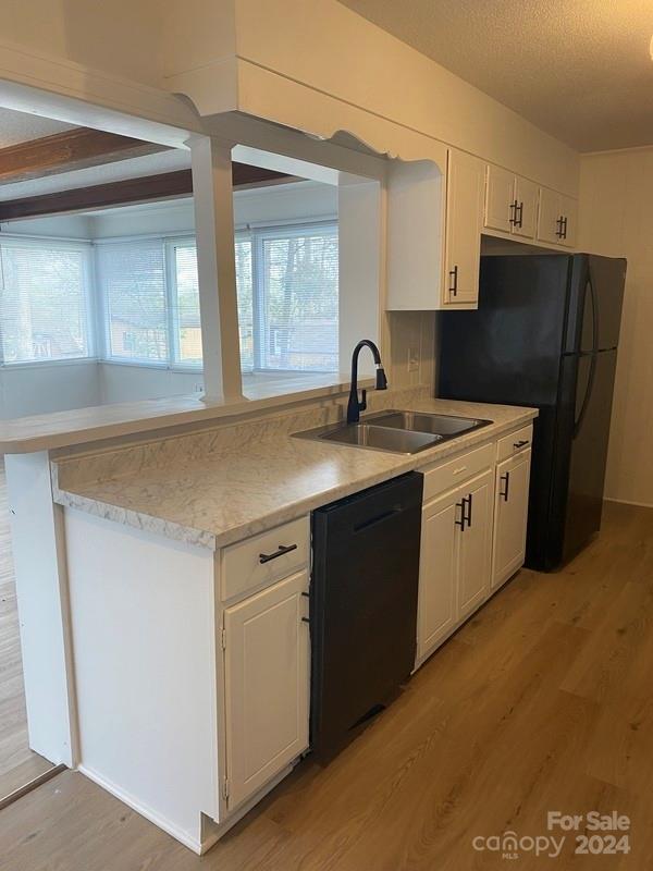 181 Spring Garden Avenue Kannapolis, NC 28081 - Photo 7 of 30 a kitchen with a sink dishwasher a refrigerator and cabinets