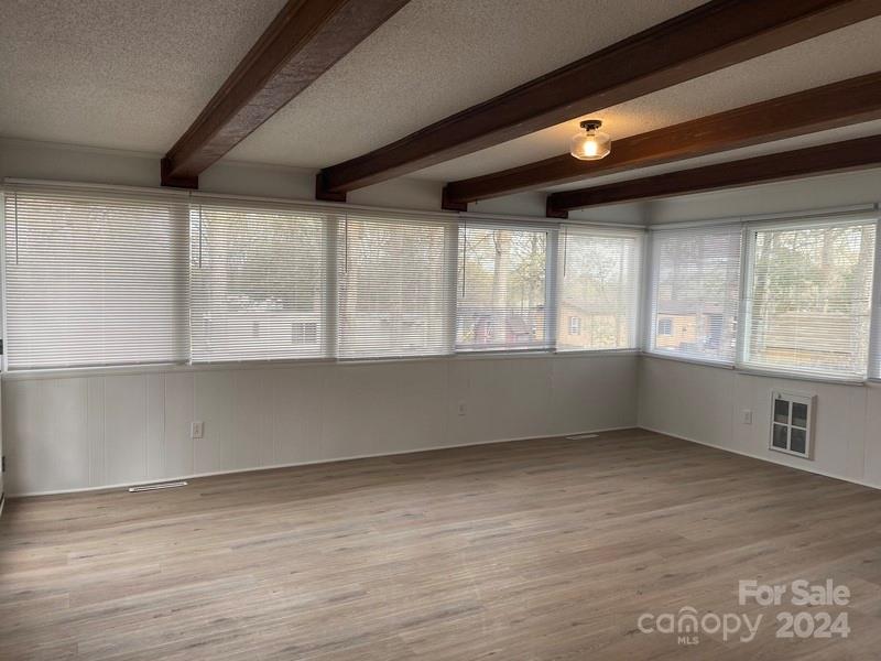 181 Spring Garden Avenue Kannapolis, NC 28081 - Photo 9 of 30 an empty room with wooden floor and windows