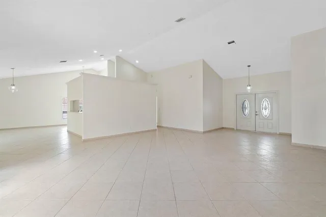 a view of an empty room with glass door