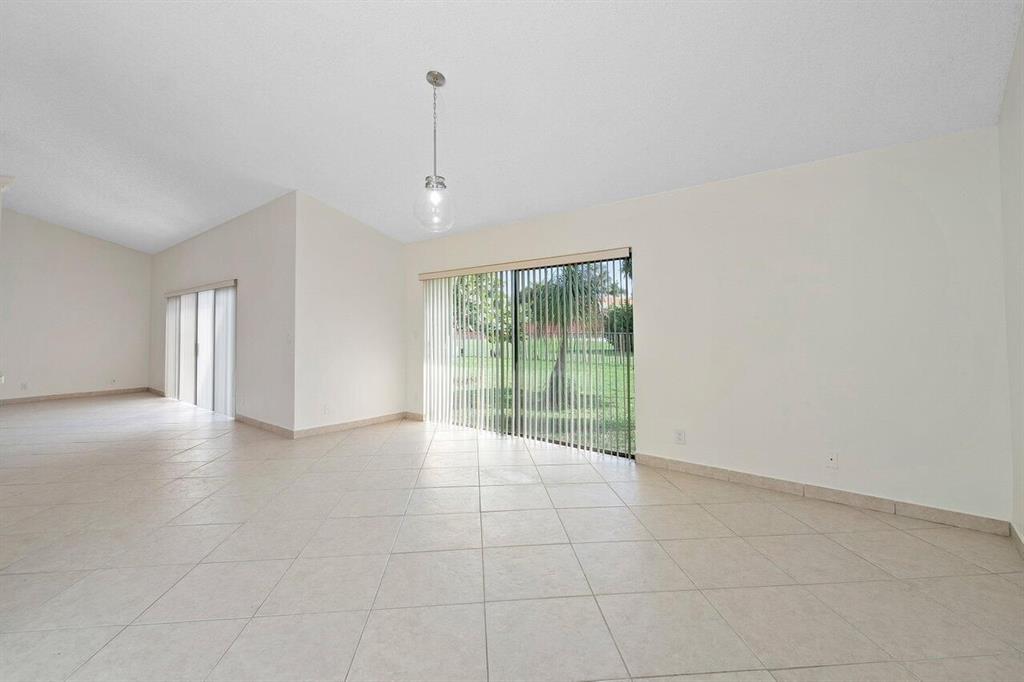 9398 Laurel Green Drive Boynton Beach, FL 33437 - Photo 5 of 19 a view of an empty room with glass door