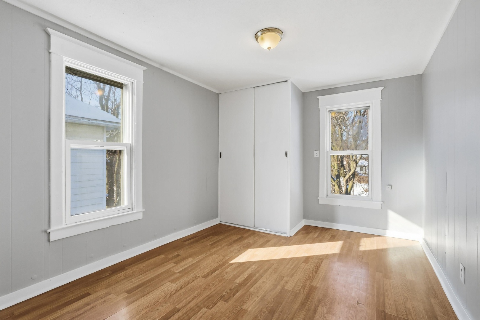1169 23rd Street Moline, IL 61265 - Photo 14 of 20 an empty room with wooden floor and windows