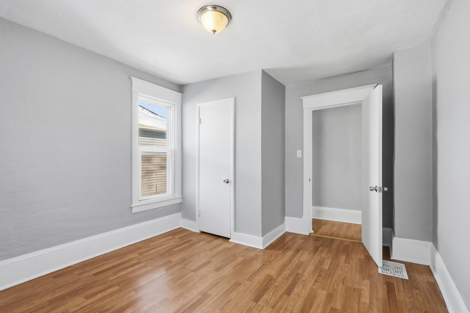 1169 23rd Street Moline, IL 61265 - Photo 18 of 20 an empty room with wooden floor and windows