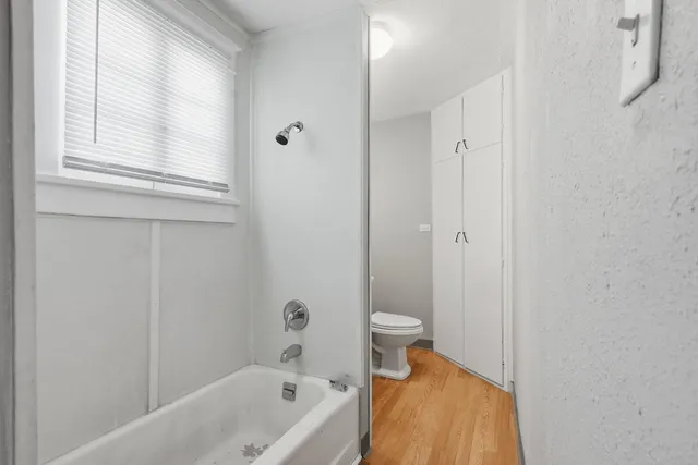 a bathroom with a bathtub and a toilet