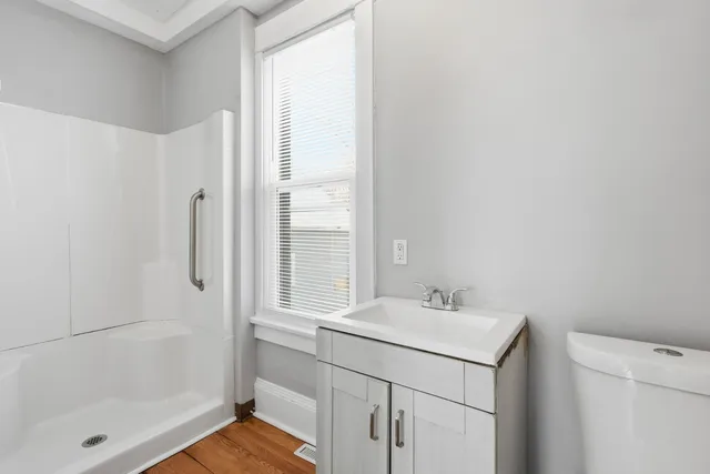 a bathroom with a sink a mirror and a shower