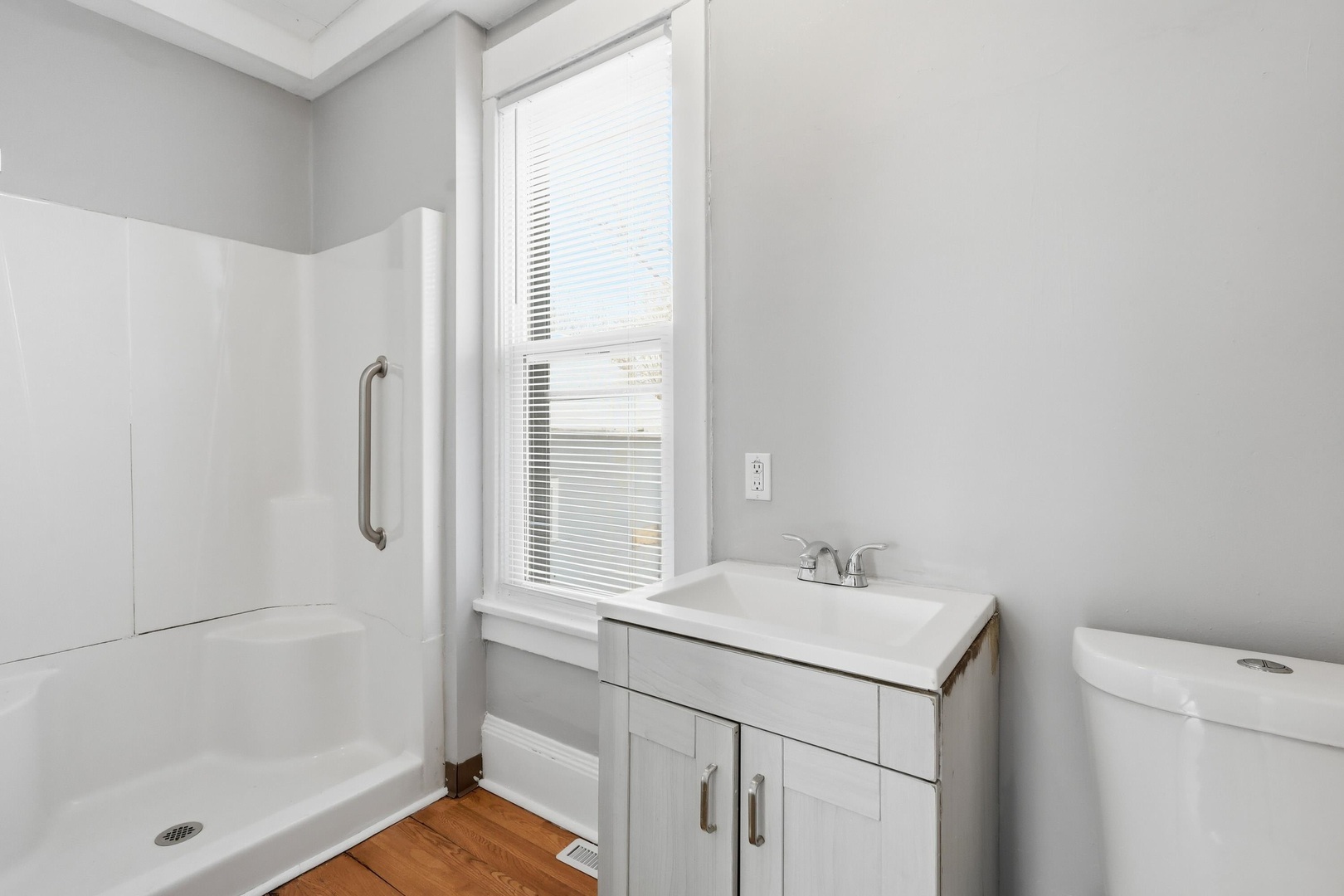 1169 23rd Street Moline, IL 61265 - Photo 9 of 20 a bathroom with a sink a mirror and a shower