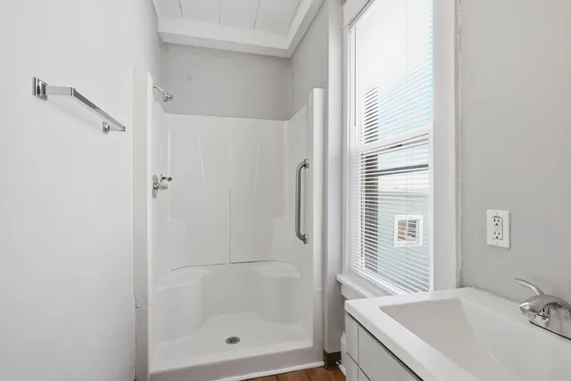 a bathroom with a tub shower and sink